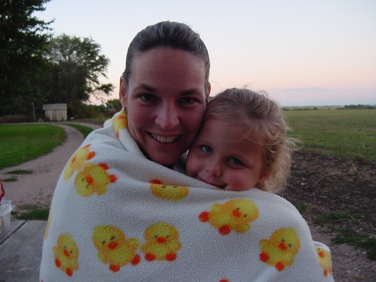 Em and me back in 2004 wrapped in a duck blanket on a chilly night by a bonfire.